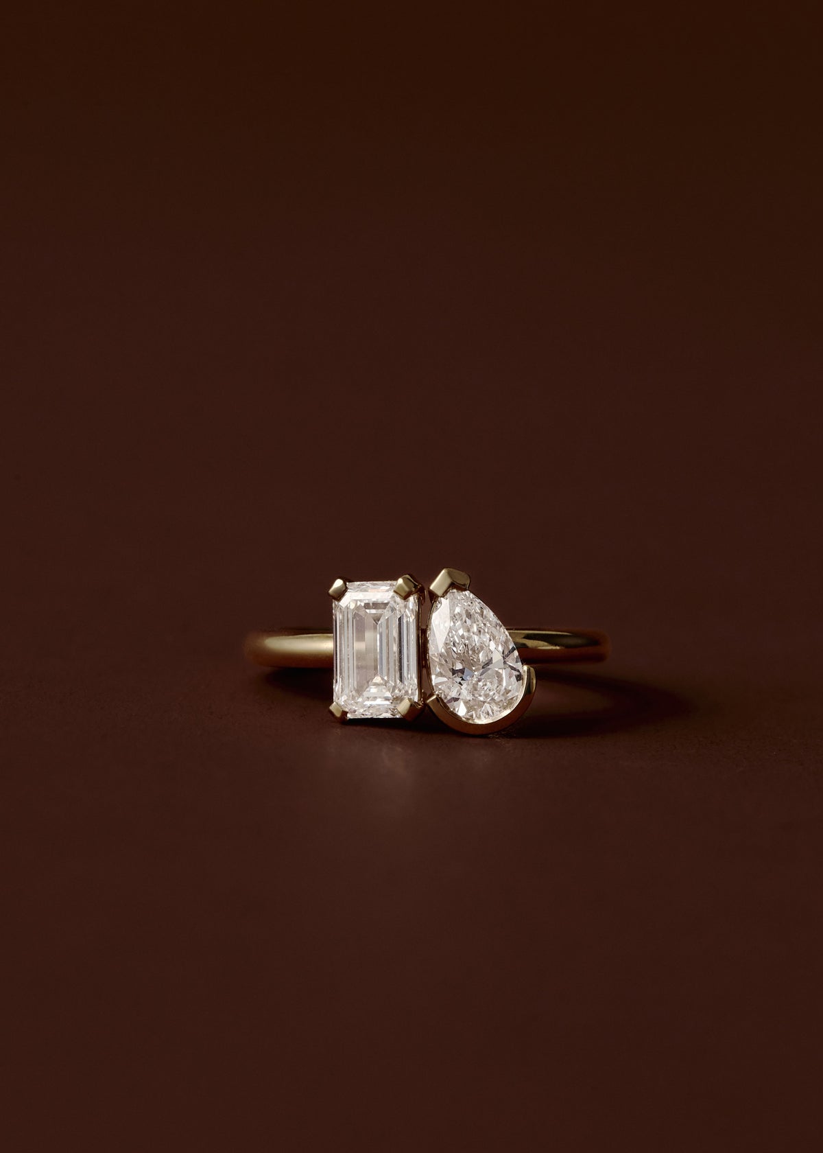 Pear and emerald cut diamond toi et moi engagement ring in yellow gold