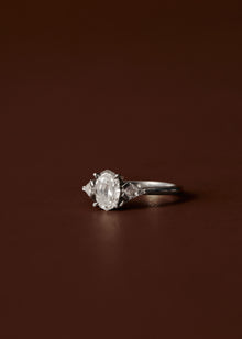 Oval diamond engagement ring with kite cut diamond side stones