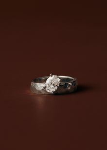 Tilted oval diamond engagement ring with wide hammered yellow gold band