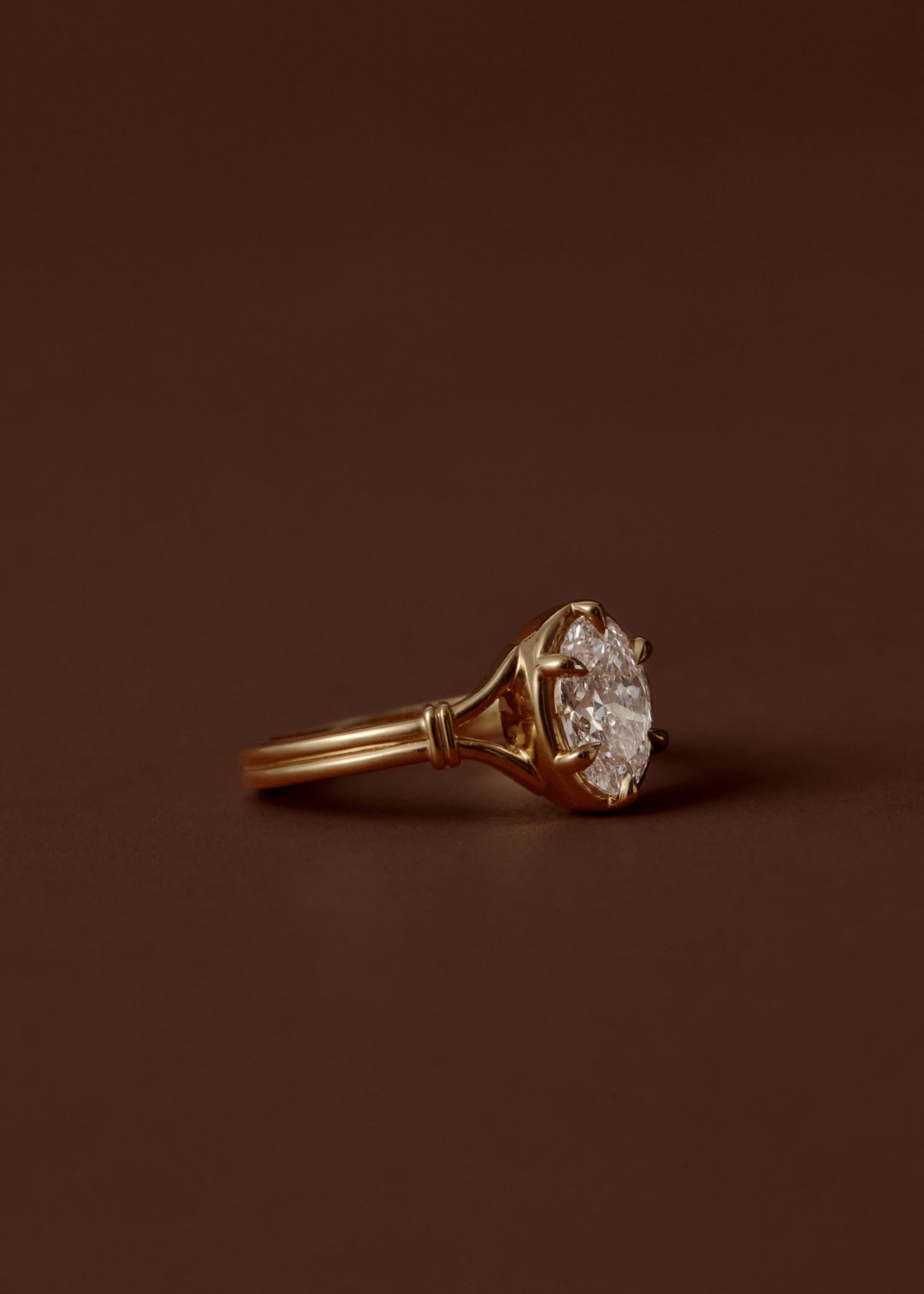 1.50ct Oval diamond split shank engagement ring with six talon claws and collet setting