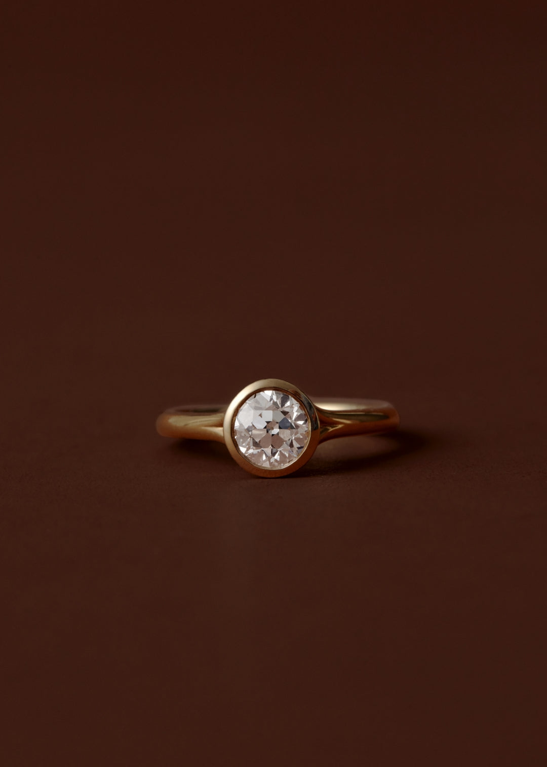 Bezel set diamond engagement ring with split shank band