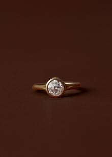 Bezel set diamond engagement ring with split shank band