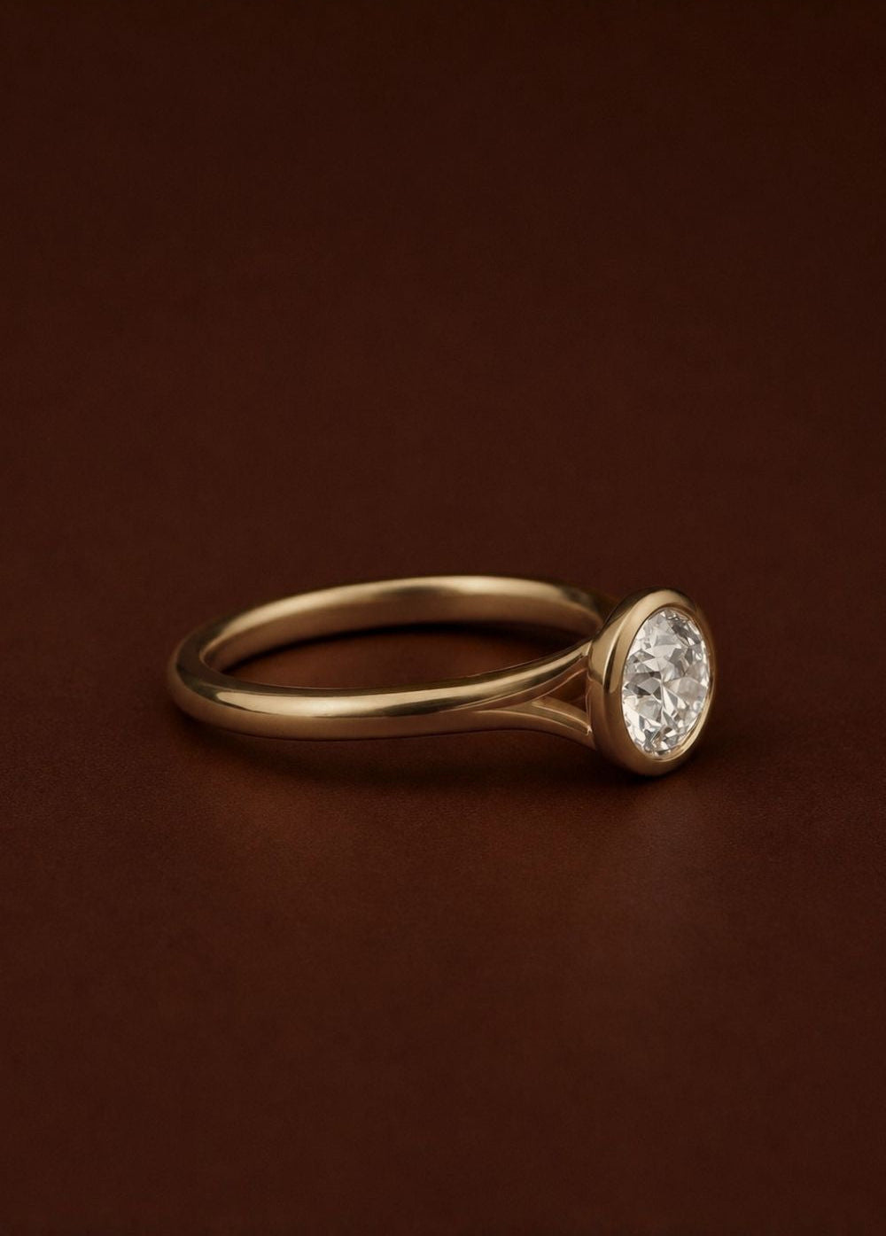 Raised bezel diamond solitaire engagement ring with split shank band