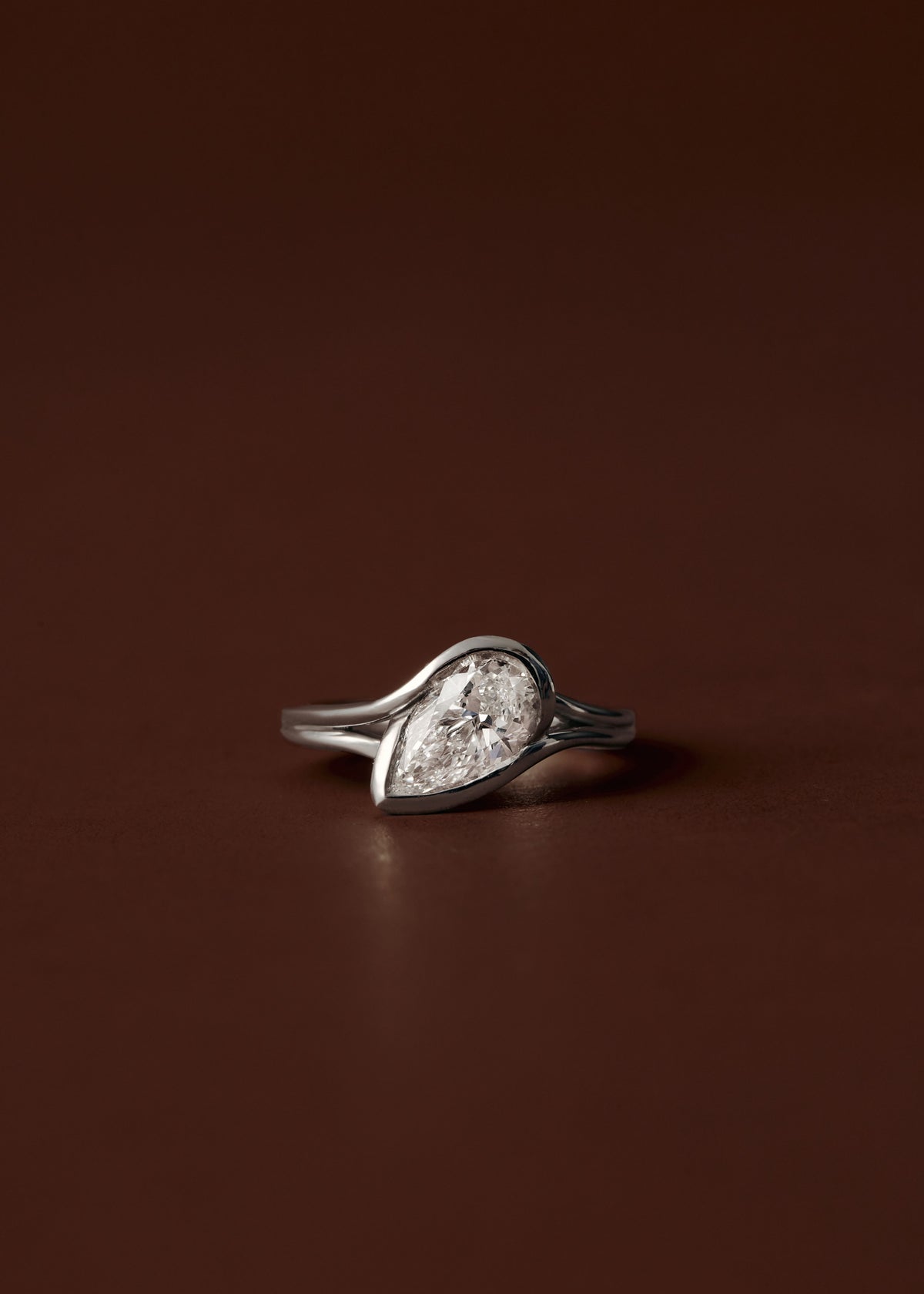 1.50ct Pear diamond engagement ring with sculpted semi bezel setting and double wire band