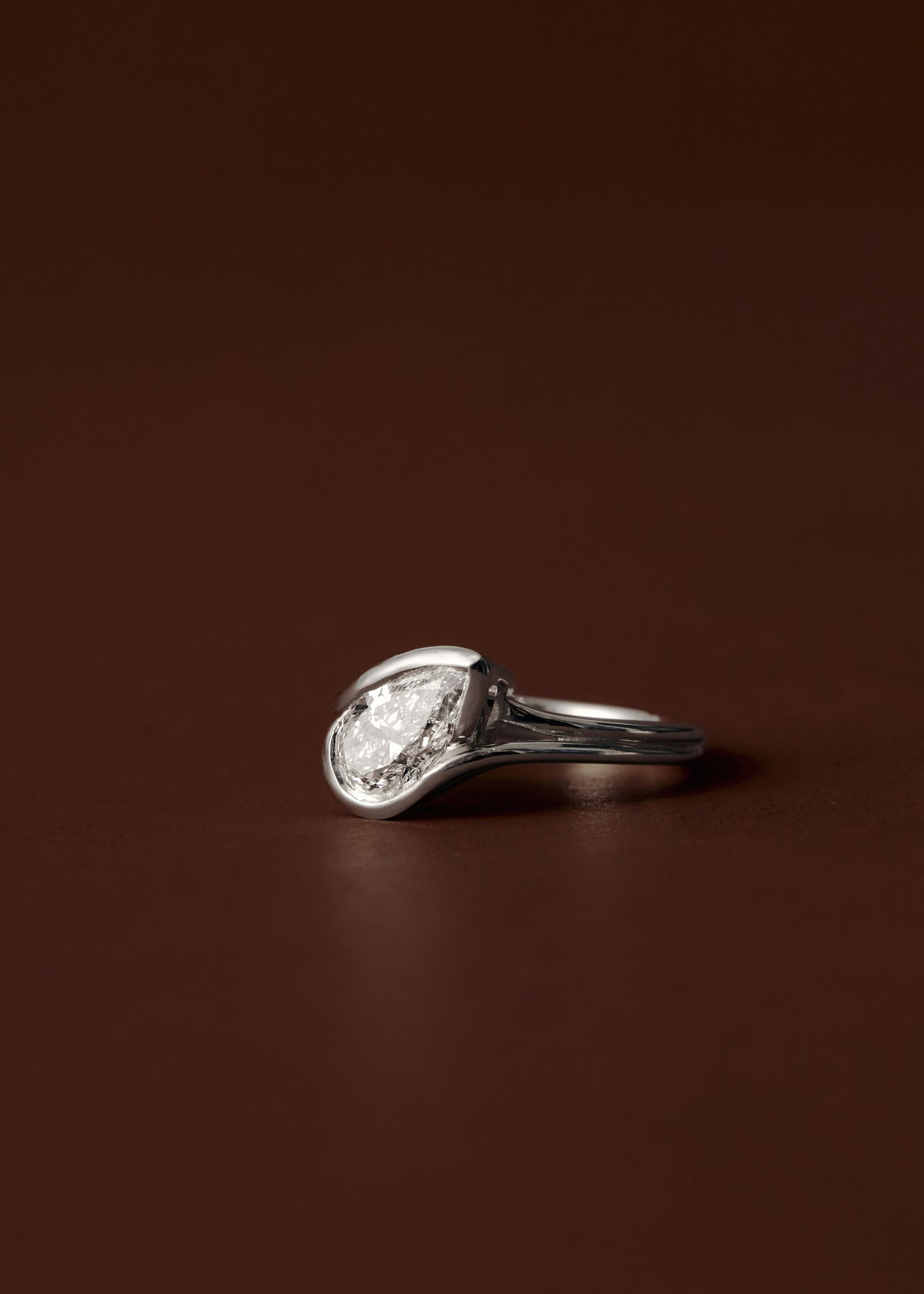 1.50ct Pear diamond engagement ring with sculpted semi bezel setting and double wire band