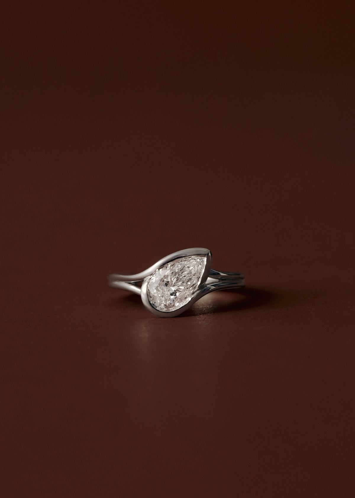 Pear diamond engagement ring with semi bezel setting and double wire band