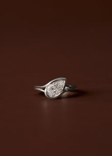 Pear diamond engagement ring with semi bezel setting and double wire band