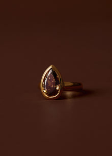 Champagne pear diamond engagement ring with bezel setting and wide gold band